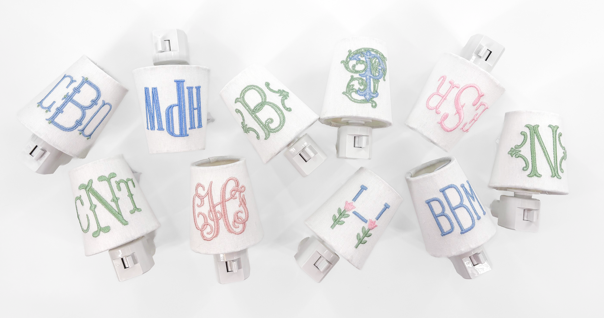 Set of personalized nightlights with monogram designs on a white background